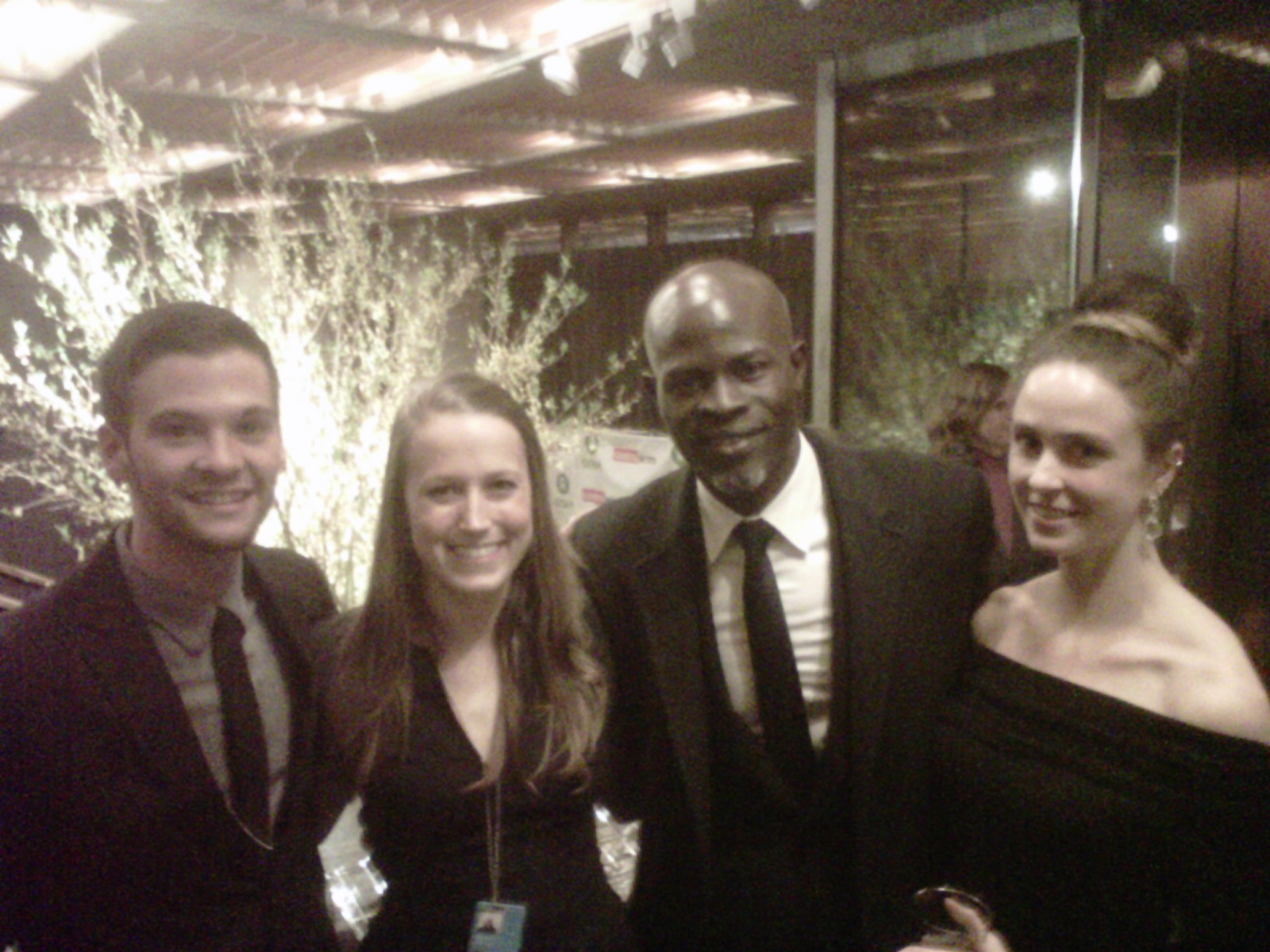 Pace University New York City students John Ciccarelli (left), Amanda Orcutt '13 (second from left) and Gillian Ashdown with Djimon Hounsou (second from right), two-time Academy Award-nominated actor and Oxfam Ambassador, at a meeting of campaigners and diplomats working on the Arms Trade Treaty negotiations in New York.