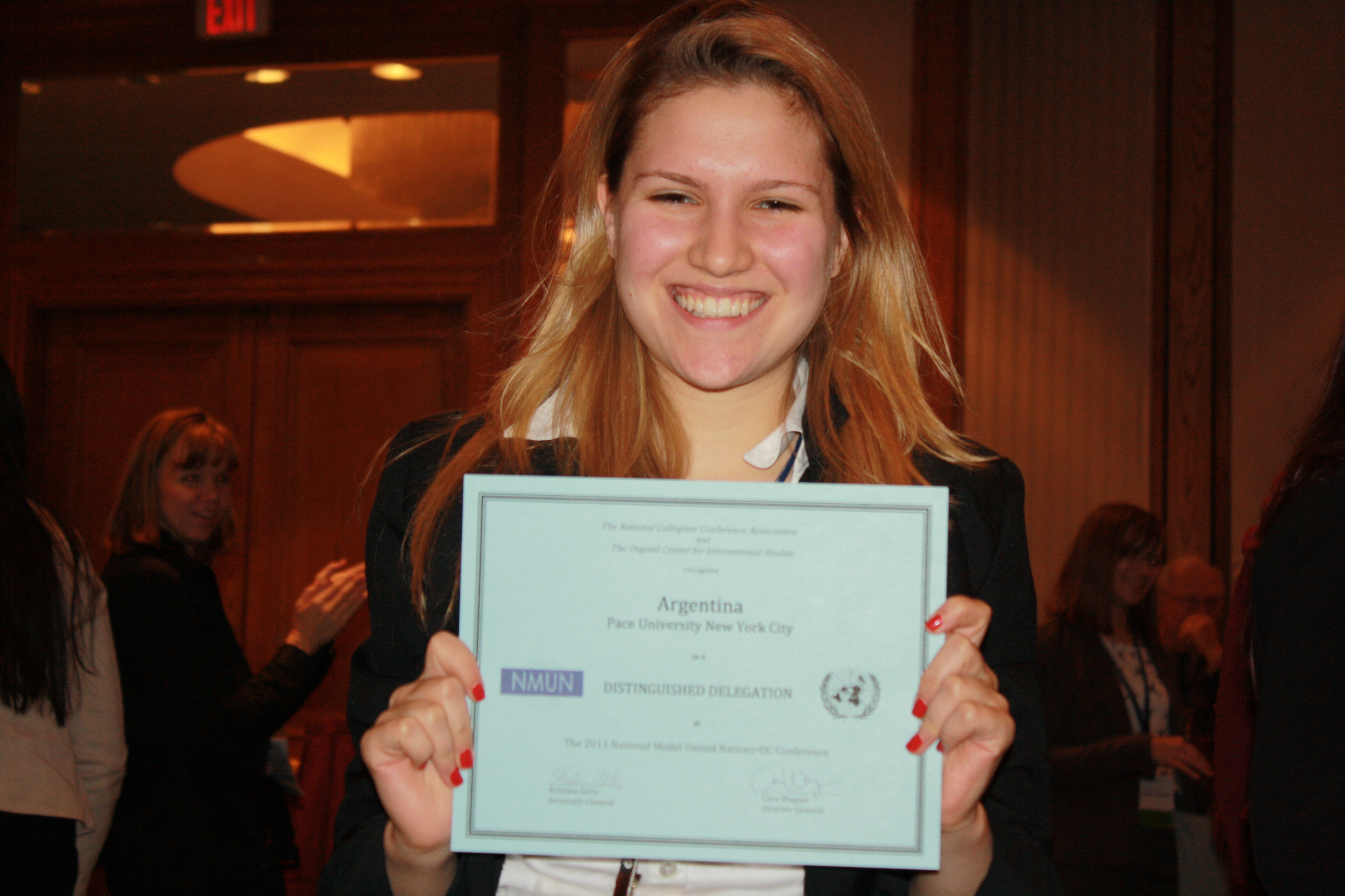 Katie James '14, Pace University New York City Model UN head delegate, shows of the award received by the students representing ?? at the 2013 National Model UN conference in Washington DC.