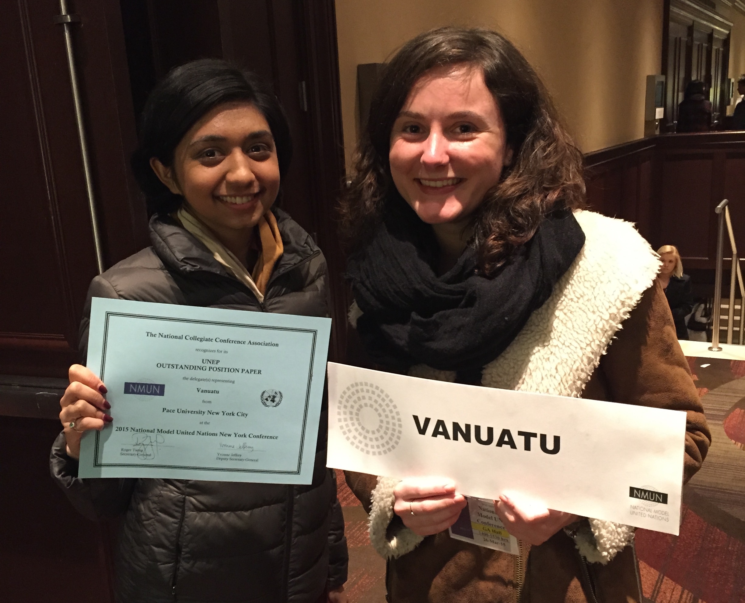 Pace students Sherin Shetty (left) and Amandine Tristani (right), displaying their Outstanding Position Paper award at the end of the 2015 National Model United Nations conference in New York City.