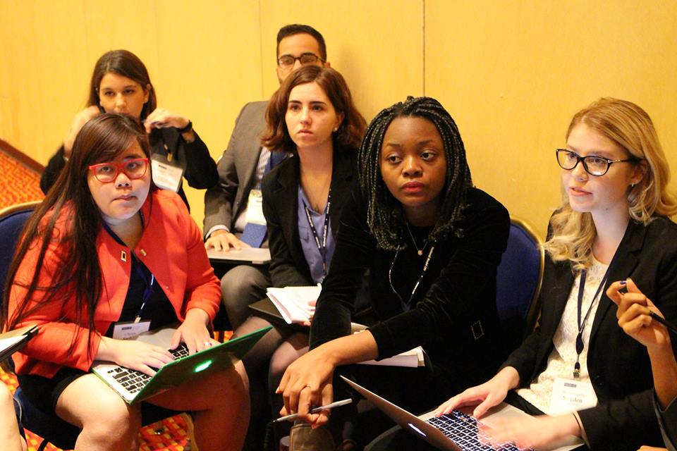 Pace University New York City students Ly Nguyen (front, left) and Kathryn Balitsos (second row, right) discuss the protection of World Heritage sites in a simulation of UNESCO at the 2015 National Model UN conference in Washington DC.